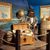 The image displays a pirate-themed exhibit featuring a life-size figure of a pirate with a backdrop of information panels about Blackbeard, framed within a maritime setting with props like a globe, treasure chest, and wooden barrels.