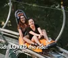 Two people are enjoying a thrilling ride on a mountain coaster laughing joyfully as they descend the track