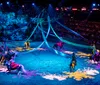 A performer in a blue costume is riding a white horse during a Christmas show at Dolly Partons Stampede Dinner Attraction